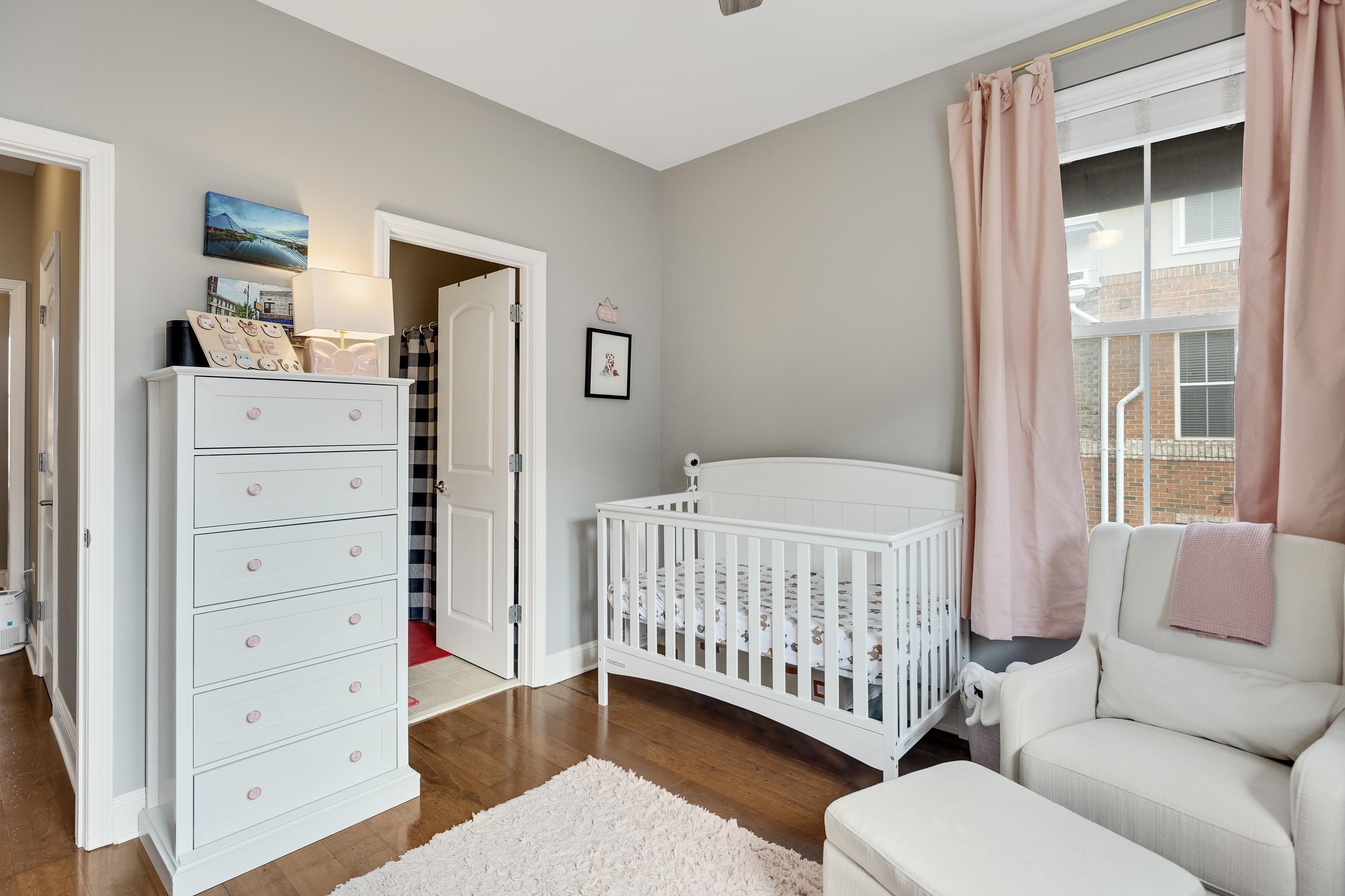 79 Shoemaker Court, Unit 108 Memphis, TN 38103 - Photo 25 of 33 a bedroom with a baby bed a couch and dresser