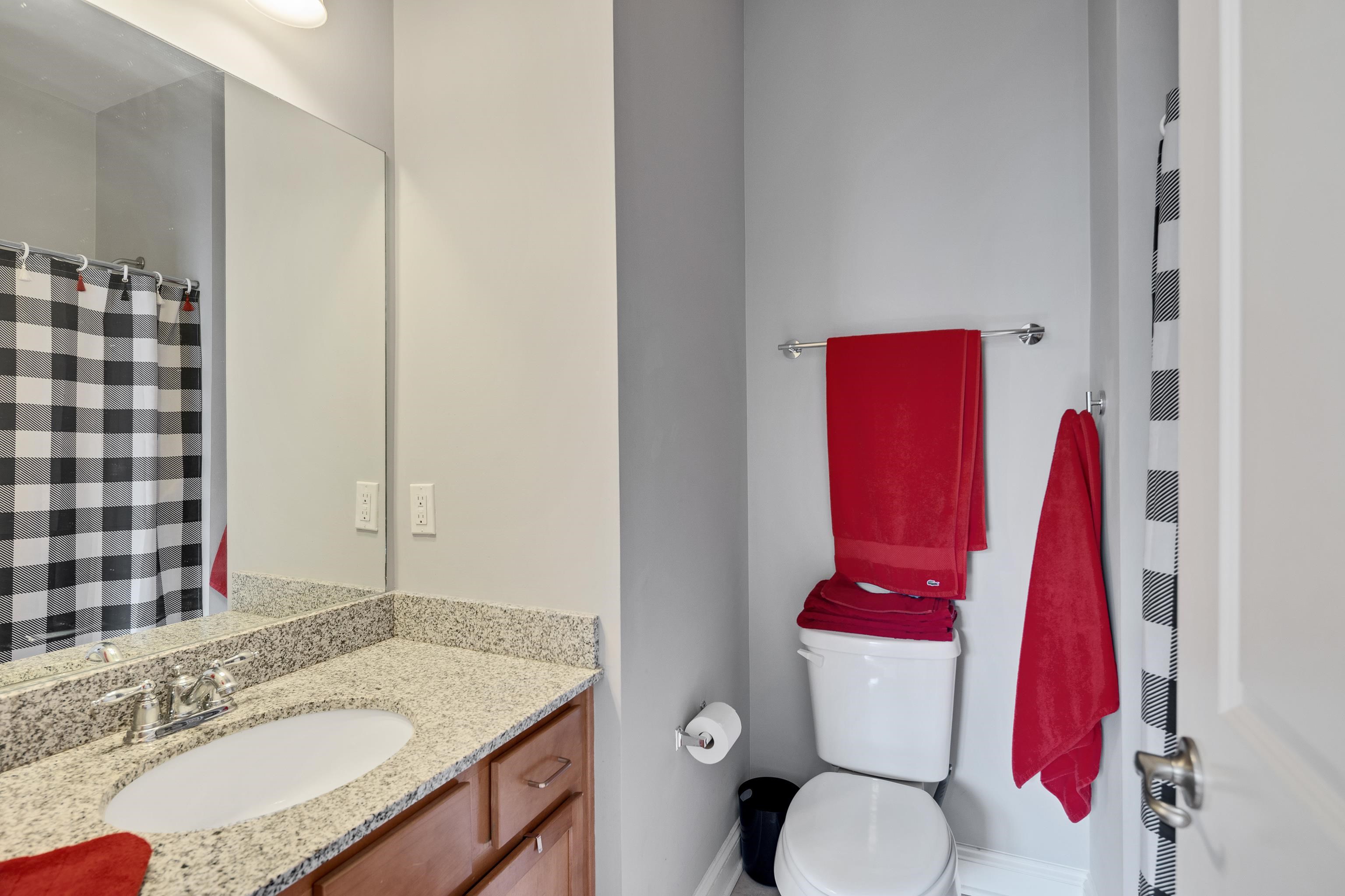 79 Shoemaker Court, Unit 108 Memphis, TN 38103 - Photo 26 of 33 a bathroom with a sink vanity mirror and toilet