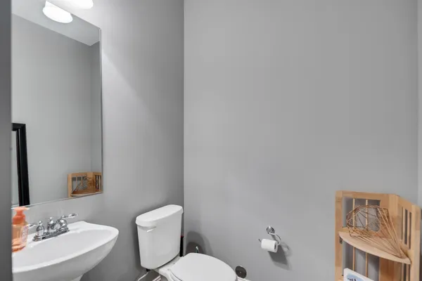 a white toilet sitting next to a bathroom sink