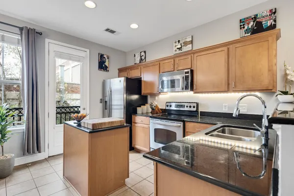 a kitchen with stainless steel appliances granite countertop a stove and a sink