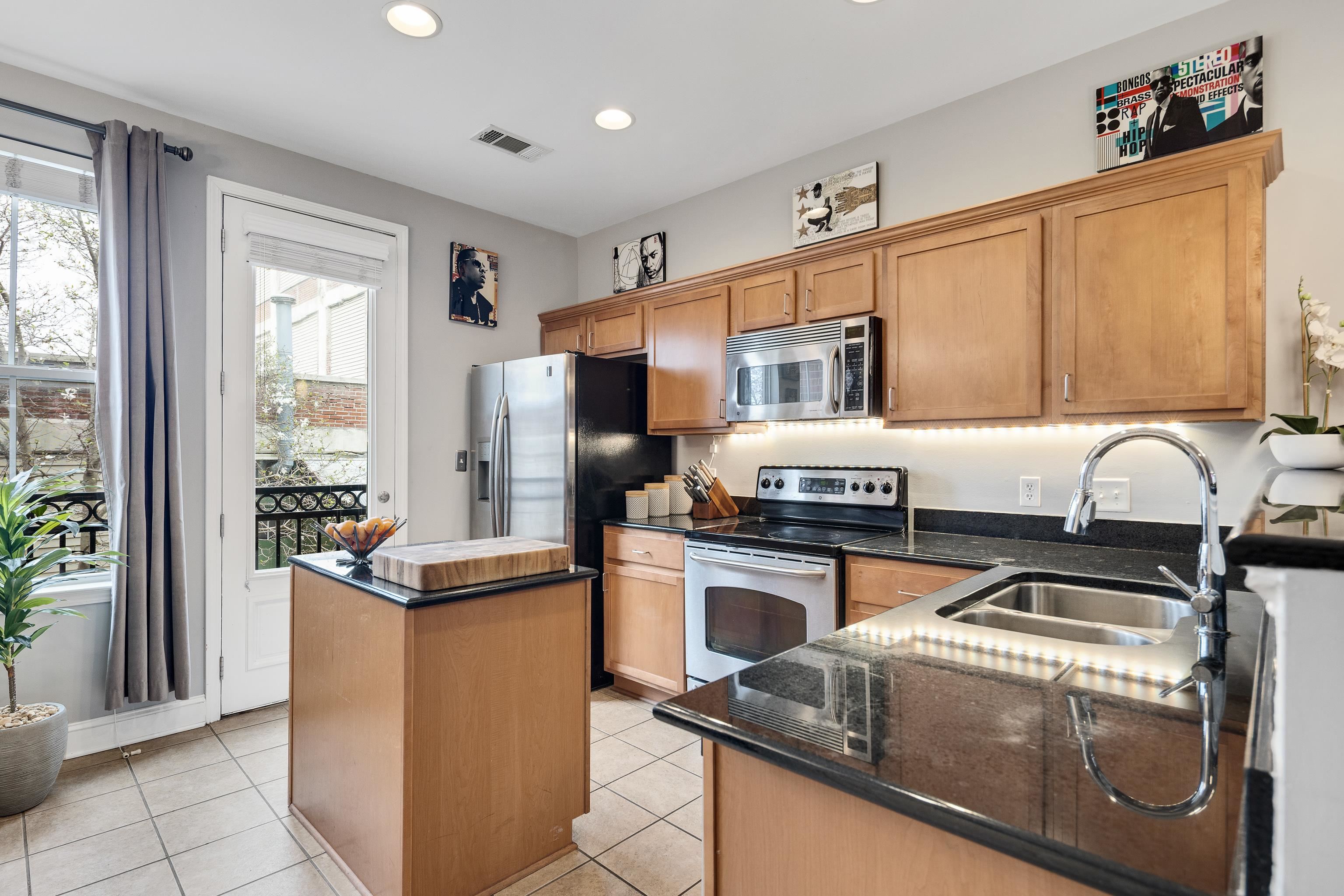 79 Shoemaker Court, Unit 108 Memphis, TN 38103 - Photo 8 of 33 a kitchen with stainless steel appliances granite countertop a refrigerator and a stove