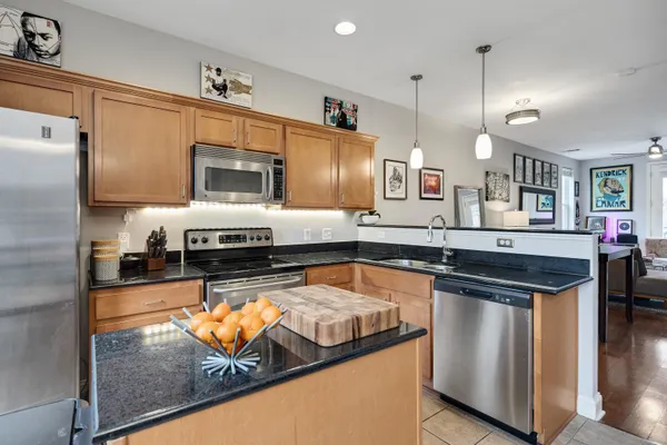 a kitchen with a table chairs refrigerator and microwave