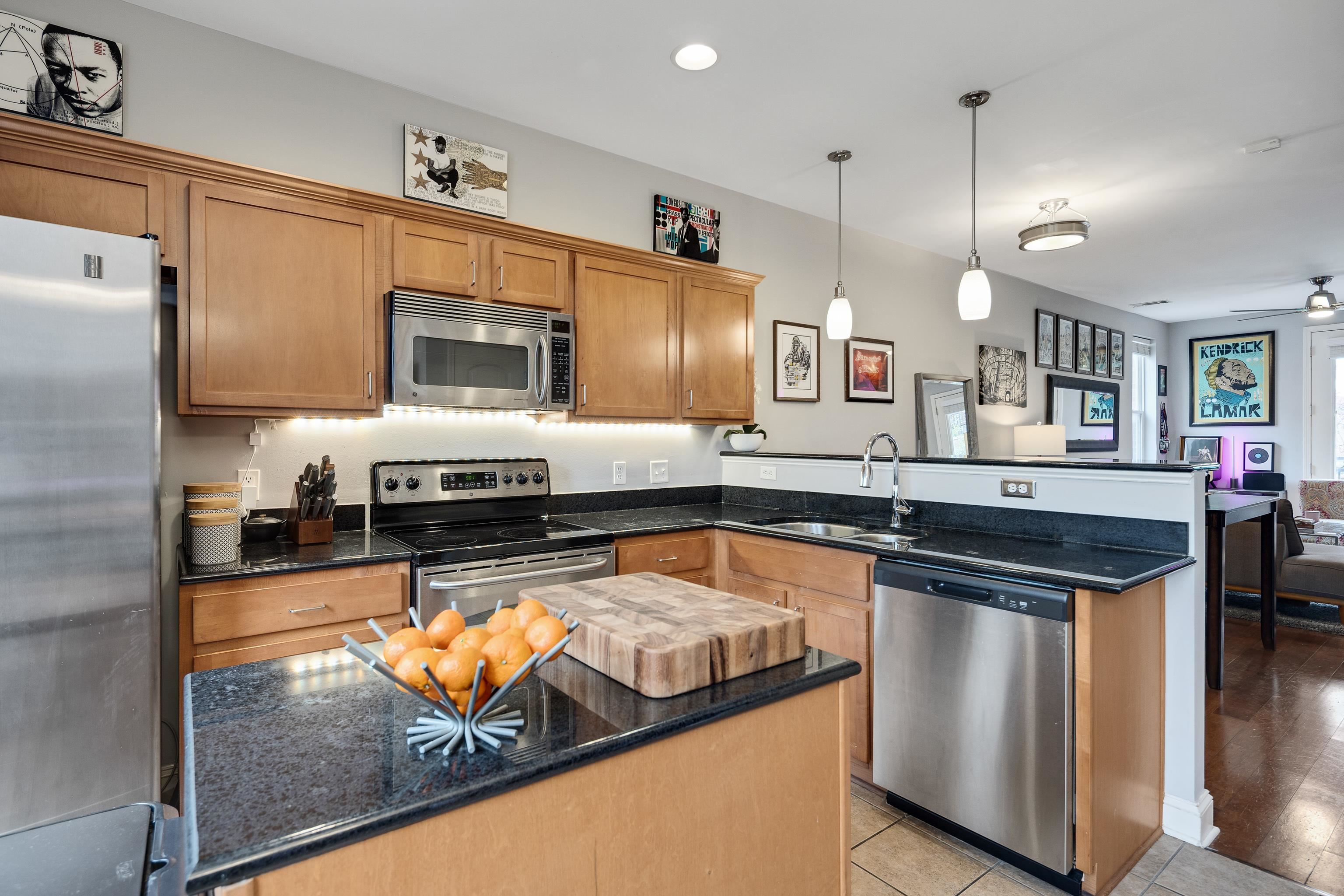 79 Shoemaker Court, Unit 108 Memphis, TN 38103 - Photo 9 of 33 a kitchen with stainless steel appliances granite countertop a stove and a sink