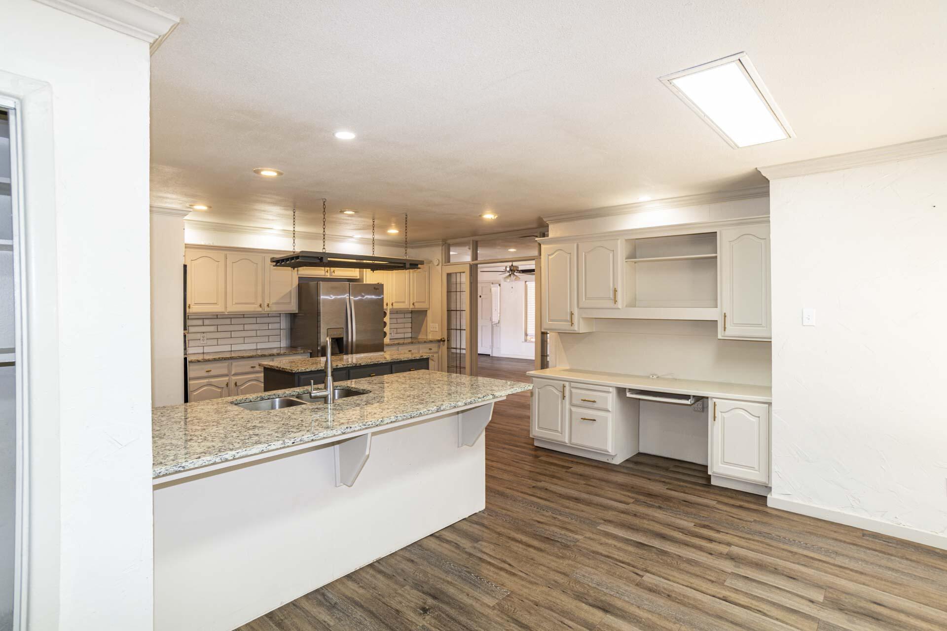 2136 57th Street Lubbock, TX 79412 - Photo 14 of 41 a large white kitchen with a stove top oven