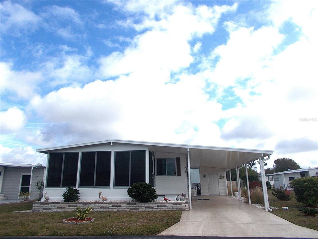 a view of a house with backyard porch and sitting area
