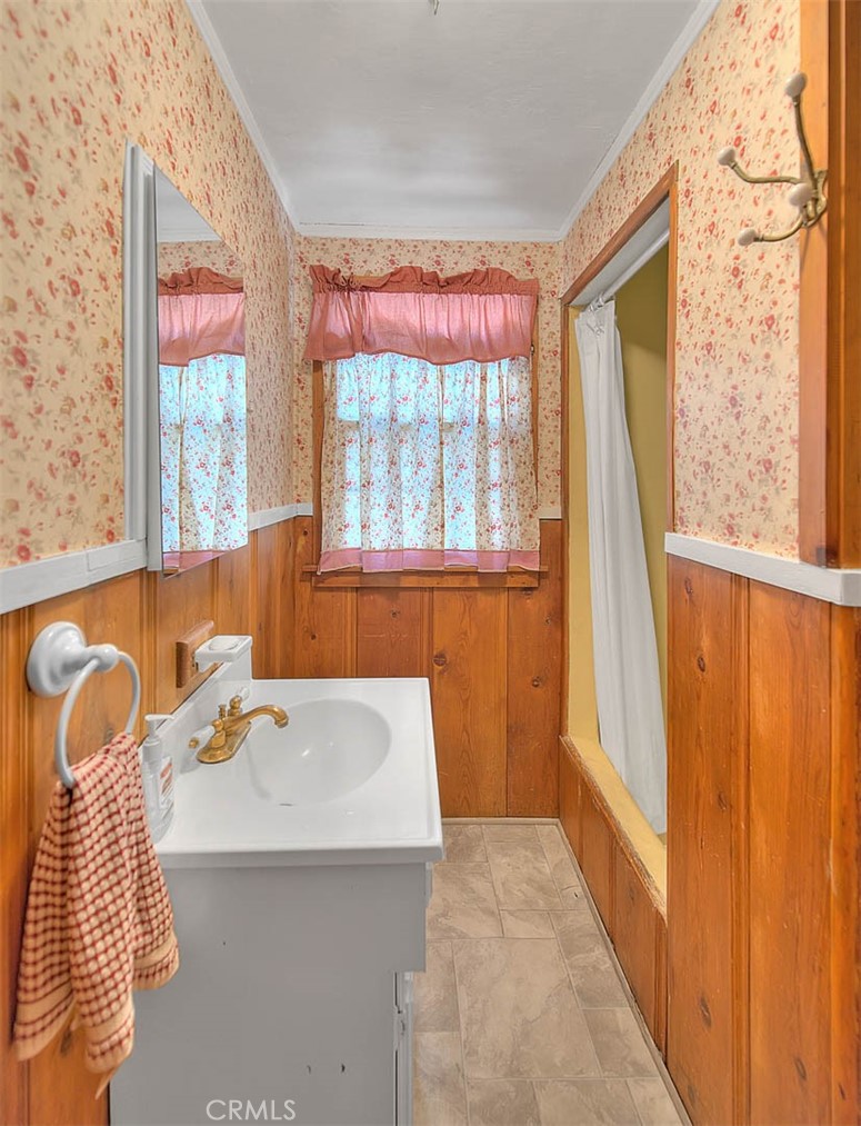 5926 Pine Street Wrightwood, CA 92397 - Photo 17 of 66 a bathroom with a sink a bathtub and next to a window