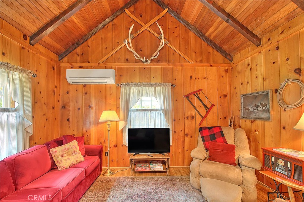 5926 Pine Street Wrightwood, CA 92397 - Photo 43 of 66 a living room with furniture a flat screen tv and a window