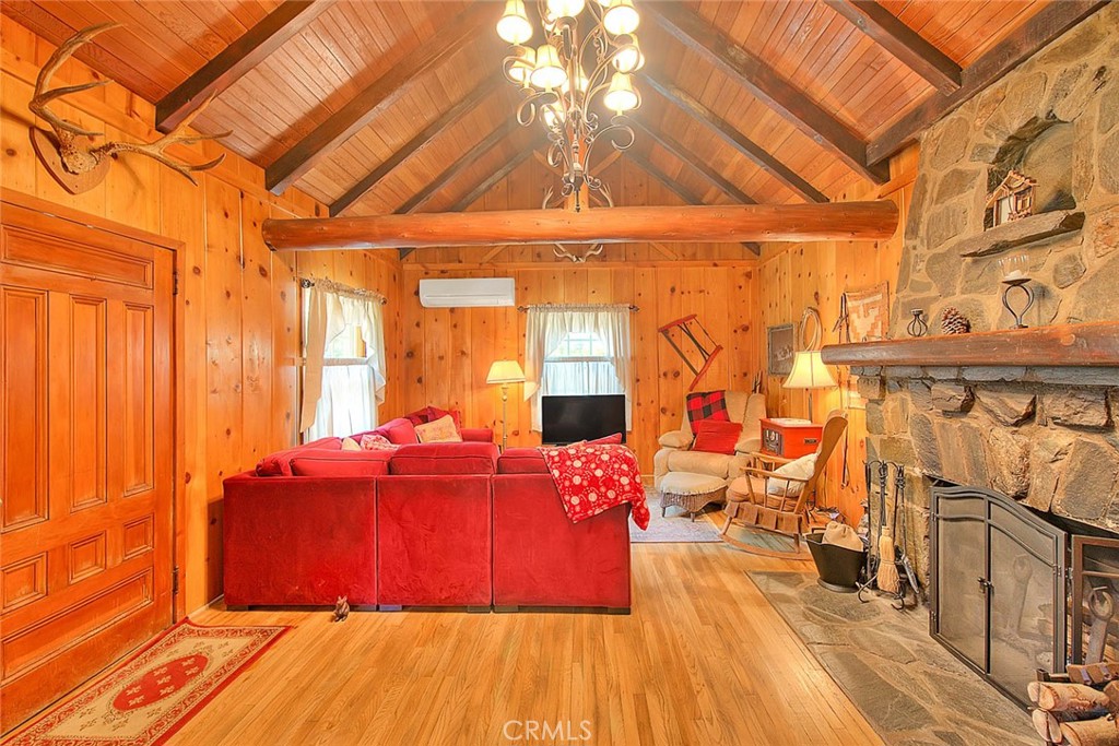 5926 Pine Street Wrightwood, CA 92397 - Photo 47 of 66 a room with lots of furniture and a chandelier