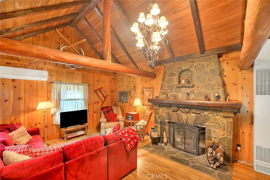 5926 Pine Street Wrightwood, CA 92397 - Photo 8 of 66 a living room with furniture a flat screen tv and a fireplace