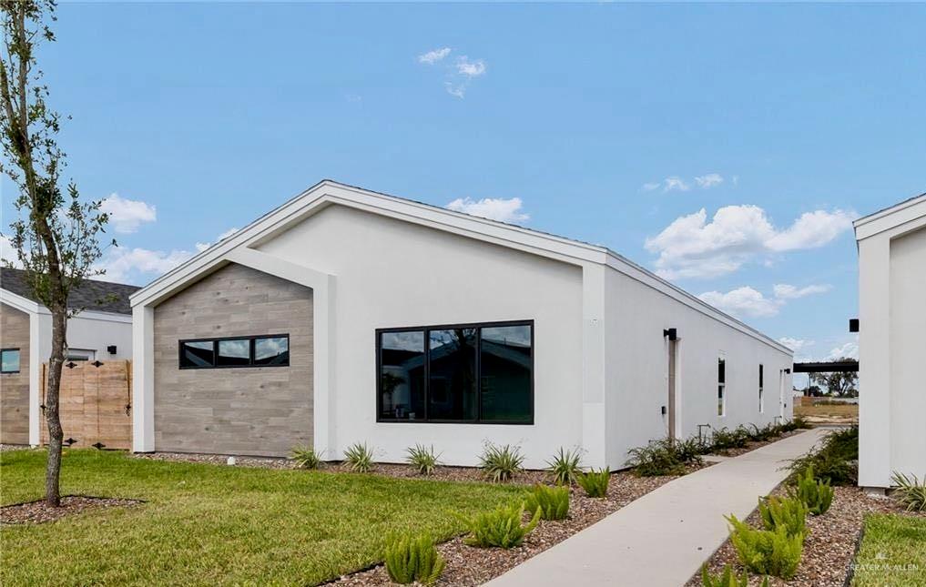 View of property exterior featuring a yard