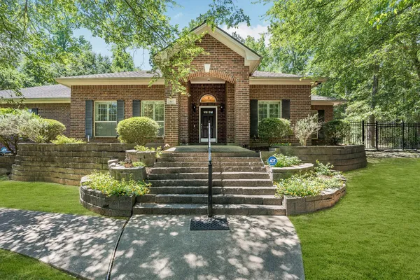 a front view of a house with garden