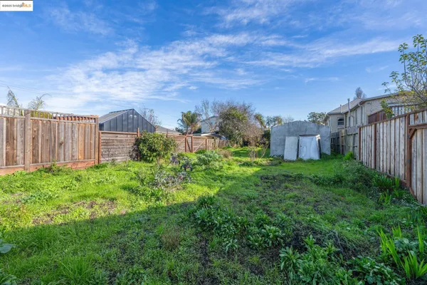 a view of a garden with a building in the background