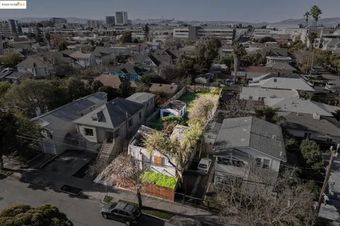 an aerial view of a house with a yard basket ball court and outdoor seating