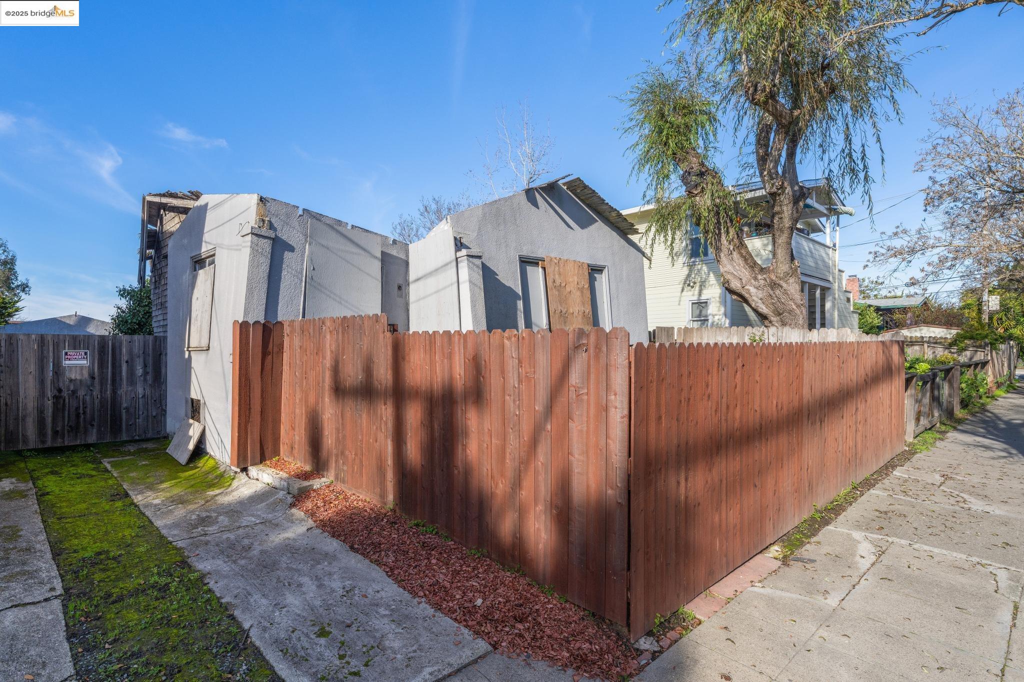 3032 Mabel Street Berkeley, CA 94702 - Photo 2 of 25 a view of a house with a small yard and large trees