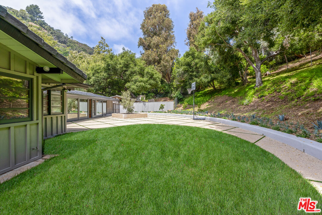 1776 Old Ranch Road Los Angeles, CA 90049 - Photo 19 of 24 a backyard of a house with table and chairs