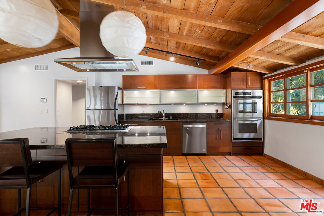1776 Old Ranch Road Los Angeles, CA 90049 - Photo 3 of 24 a kitchen with a stove and a refrigerator