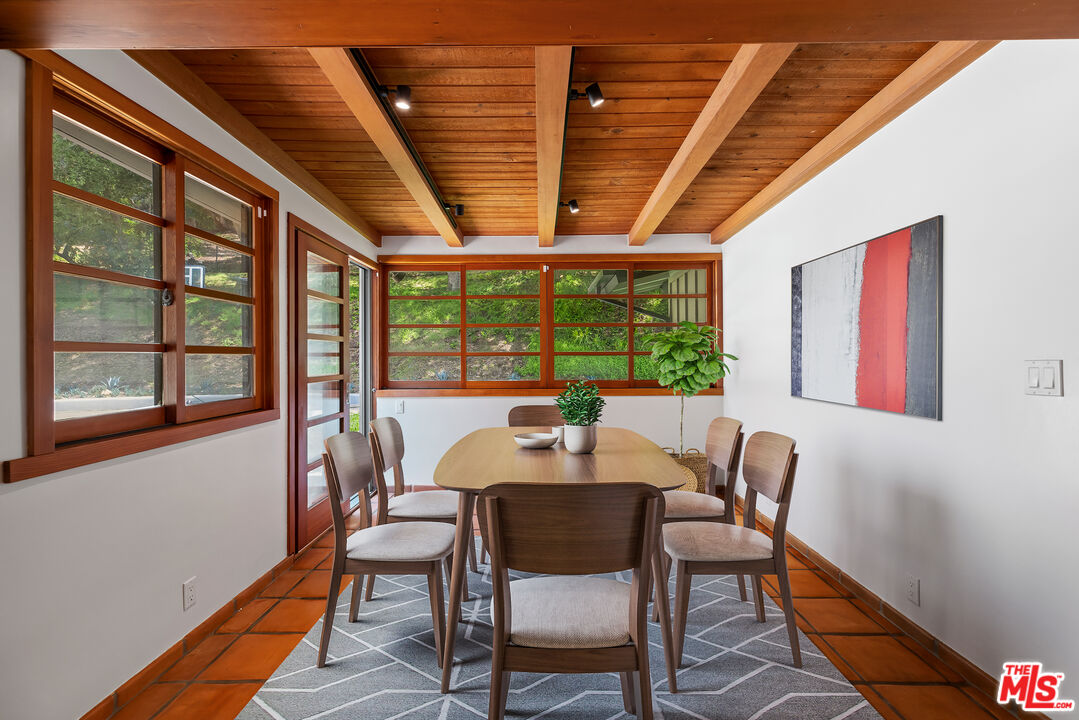 1776 Old Ranch Road Los Angeles, CA 90049 - Photo 6 of 24 a dining room with furniture a rug and wooden floor