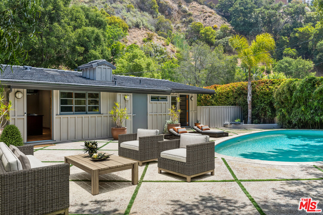 1776 Old Ranch Road Los Angeles, CA 90049 - Photo 7 of 24 a view of a house with backyard sitting area and garden