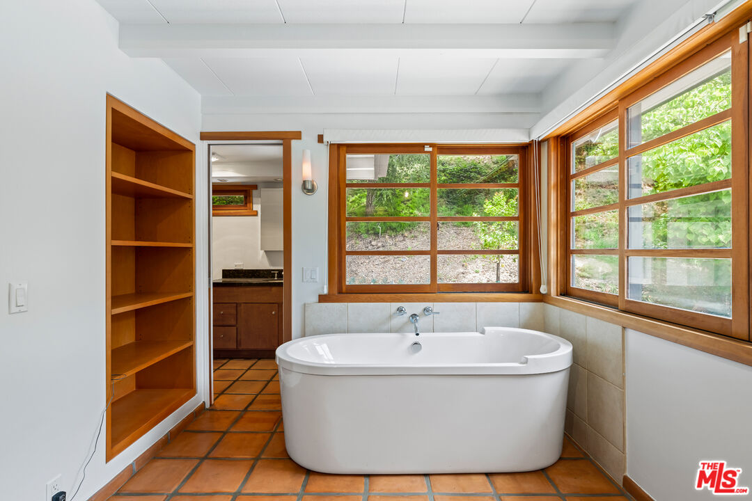 1776 Old Ranch Road Los Angeles, CA 90049 - Photo 9 of 24 a white bath tub sitting in front of a window