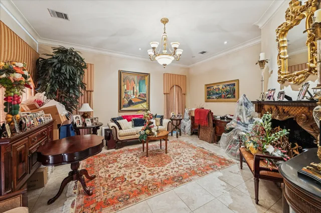 a living room with furniture a chandelier and a fireplace