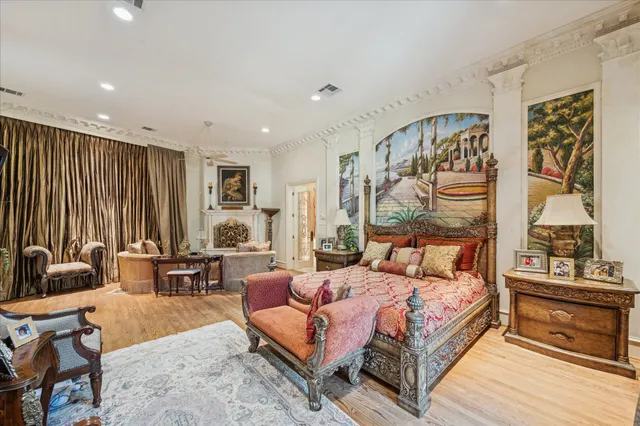 a bedroom with furniture and a large window