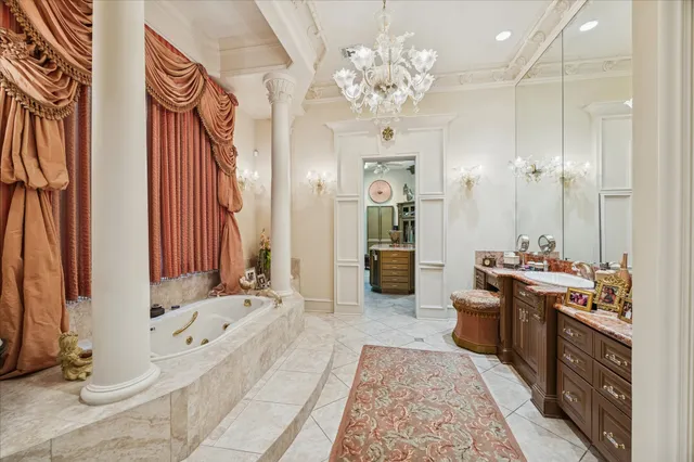 a bathroom with a tub sink and mirror