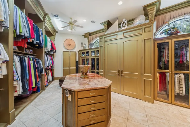 a view of walk in closet with clothes