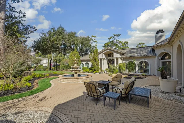 a view of a patio with dining table and chairs with a fire pit