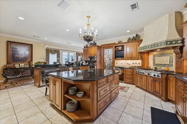 a kitchen with stainless steel appliances granite countertop a stove top oven a sink a counter top space and cabinets