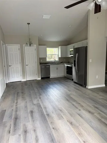 a view of kitchen with furniture and wooden floor