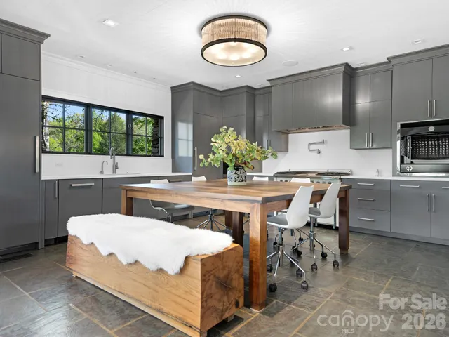 a living room with furniture and large windows