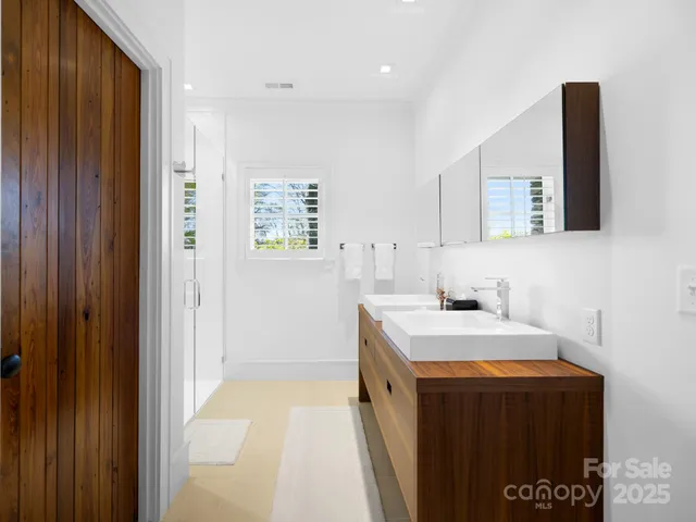 a bathroom with a sink vanity and a mirror