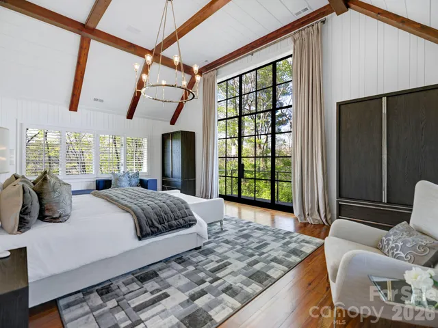 a view of a balcony with floor to ceiling windows and wooden fence