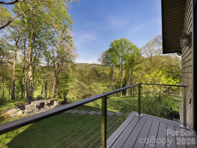 a view of a bedroom with a bed and wooden floor