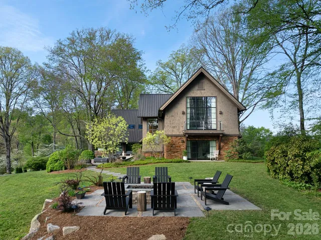 a backyard of a house with table and chairs