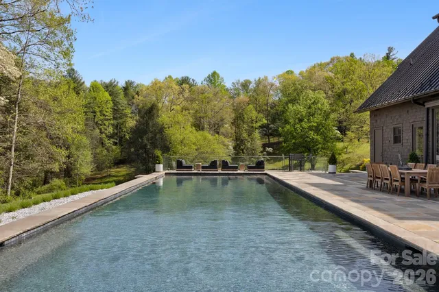 a living room with furniture and large windows