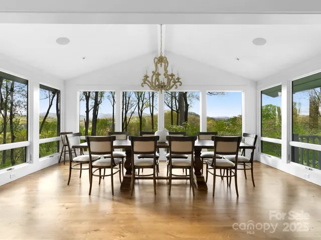 a dining room with furniture window and wooden floor