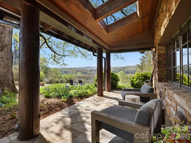 a living room with furniture a fireplace and a large window