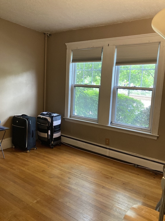 1734 Commonwealth Avenue, Unit 4 Boston, MA 02135 - Photo 3 of 15 a room with a window and a wooden floor