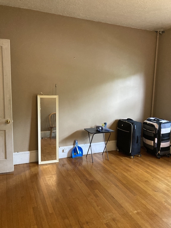 1734 Commonwealth Avenue, Unit 4 Boston, MA 02135 - Photo 4 of 15 a living room with furniture and a wooden floor