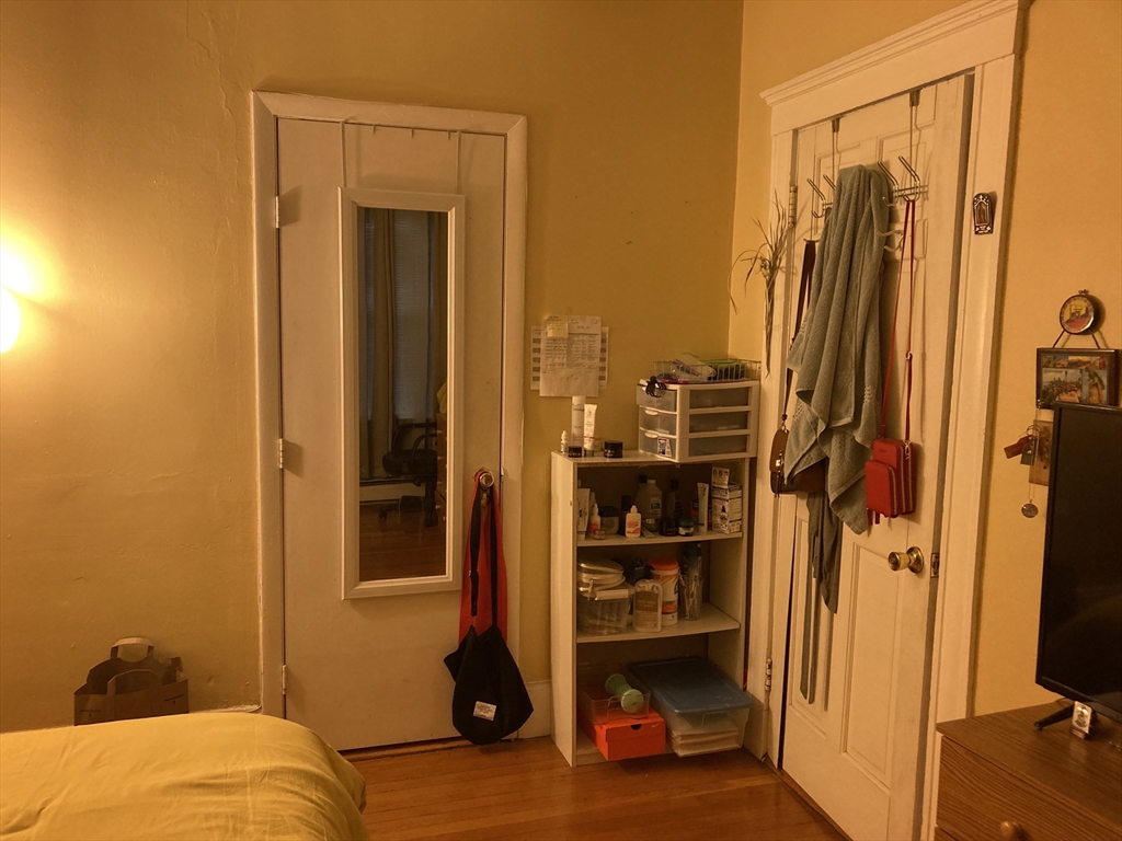 1734 Commonwealth Avenue, Unit 4 Boston, MA 02135 - Photo 9 of 15 a view of walk in closet with clothes and shoes