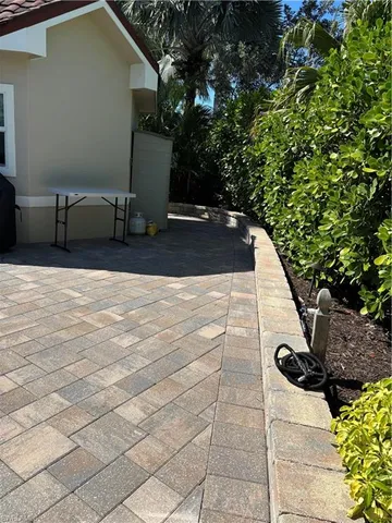 a view of a house with a potted plant and a yard
