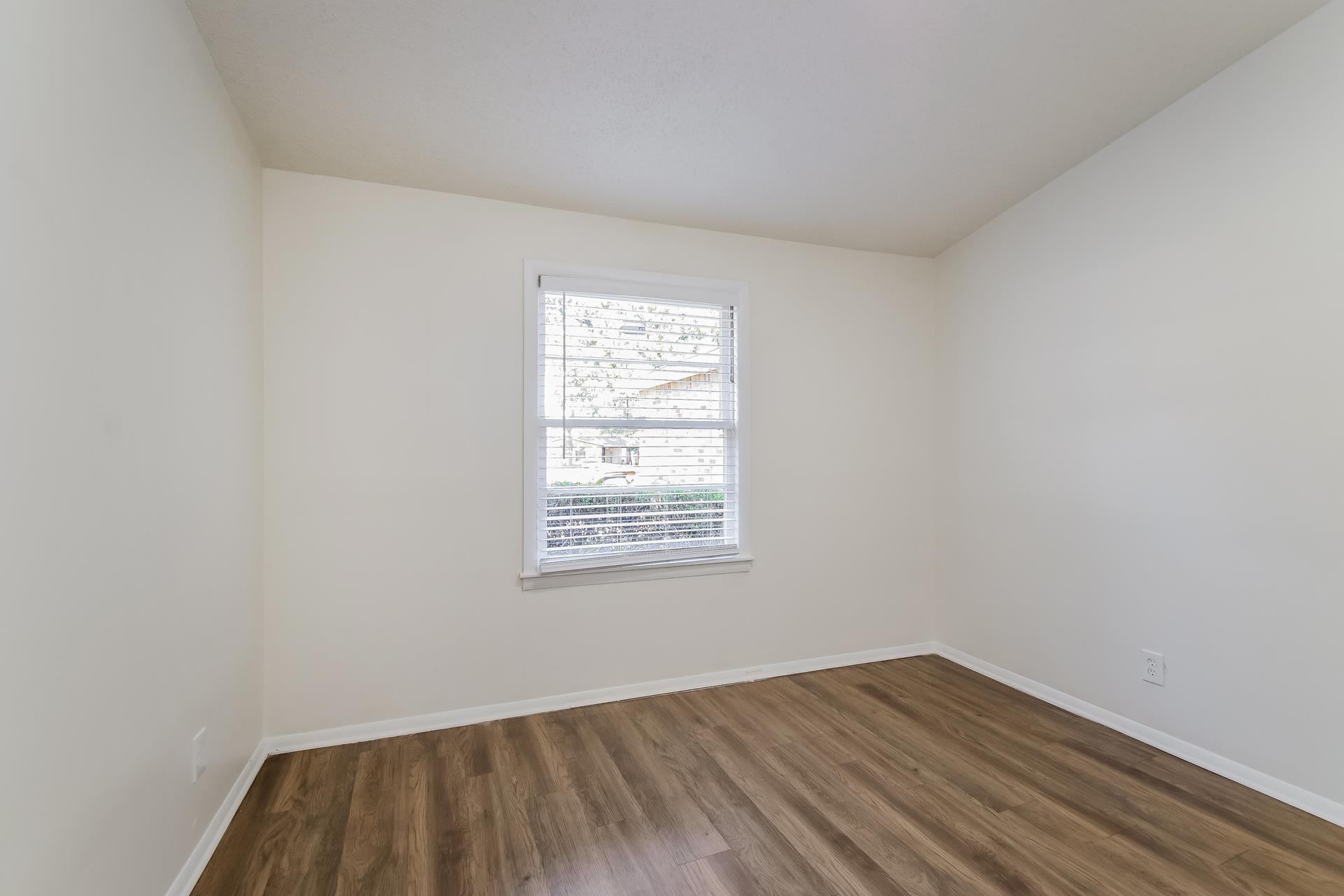 2966 Knight Road Memphis, TN 38118 - Photo 13 of 19 an empty room with wooden floor and windows