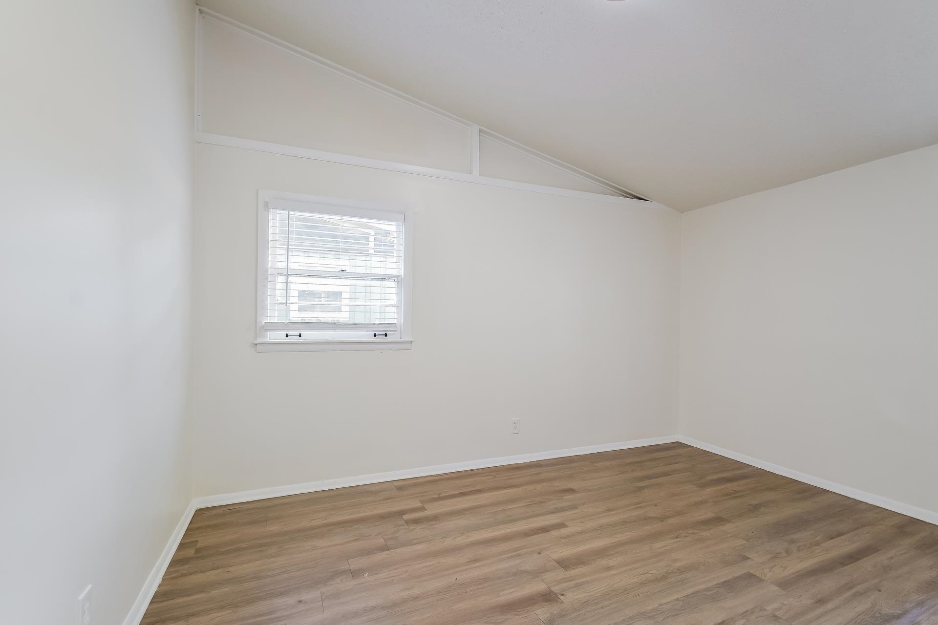 2966 Knight Road Memphis, TN 38118 - Photo 14 of 19 an empty room with wooden floor and windows