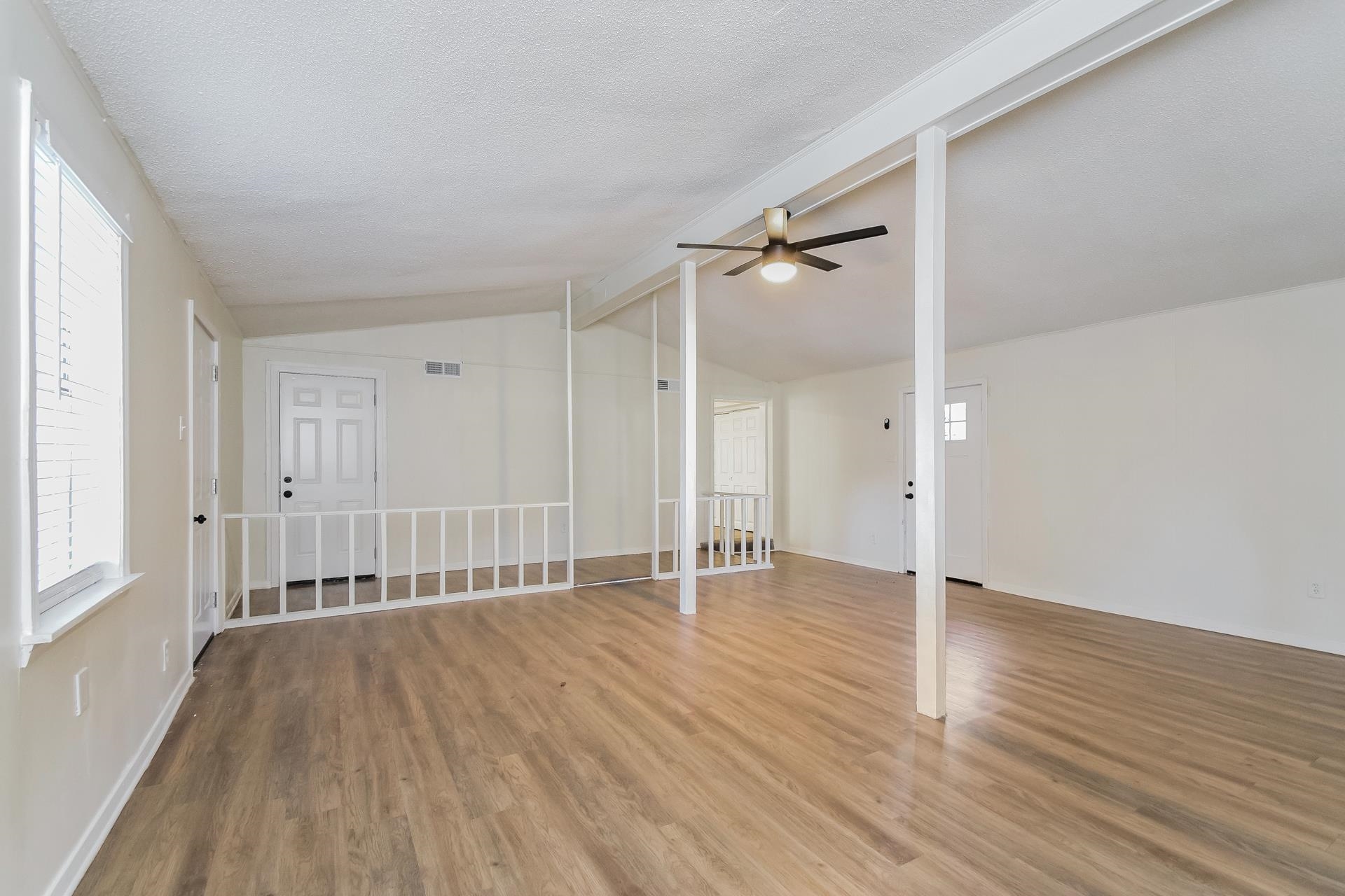 2966 Knight Road Memphis, TN 38118 - Photo 3 of 19 a view of an empty room with wooden floor and a window