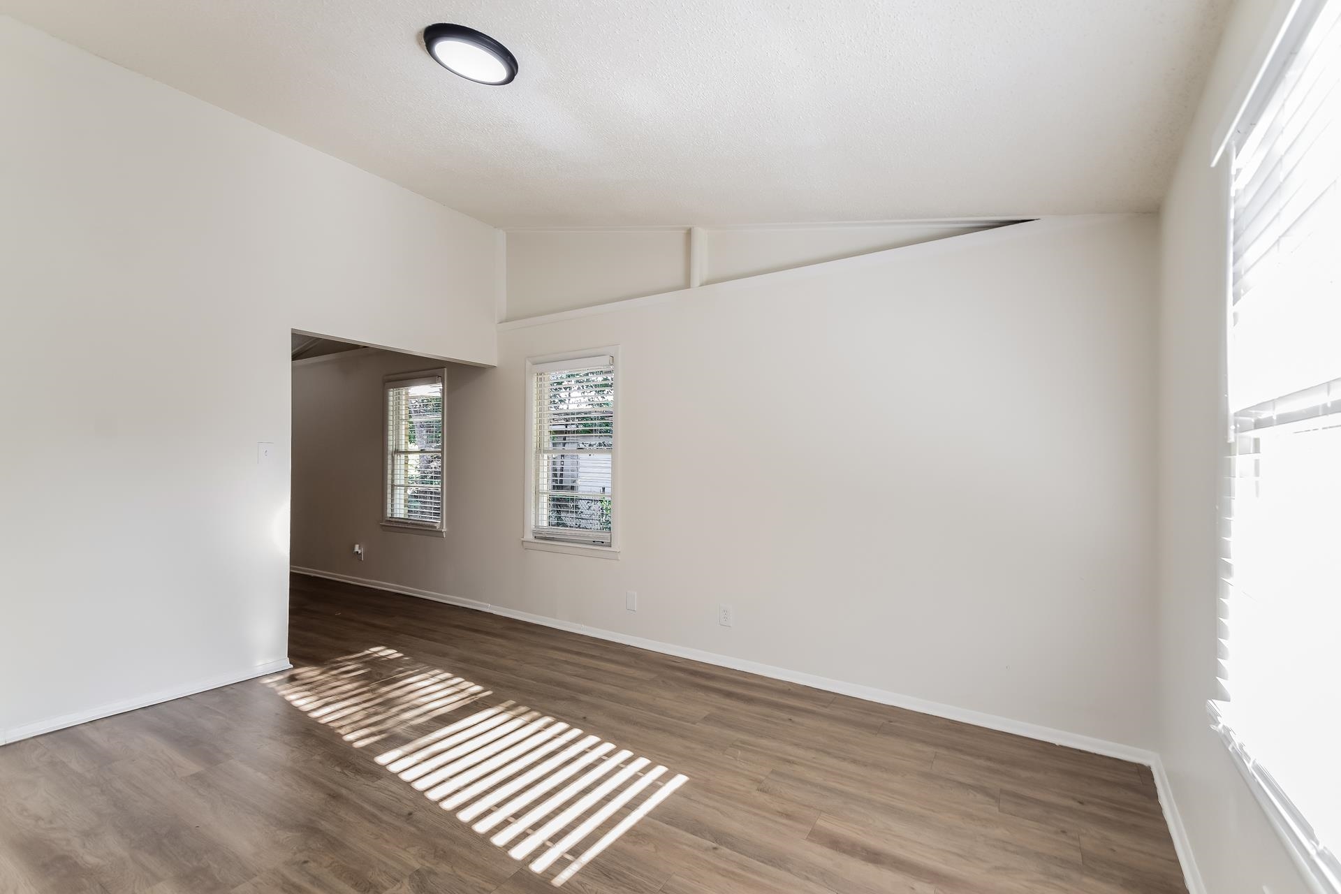 2966 Knight Road Memphis, TN 38118 - Photo 4 of 19 an empty room with wooden floor and windows
