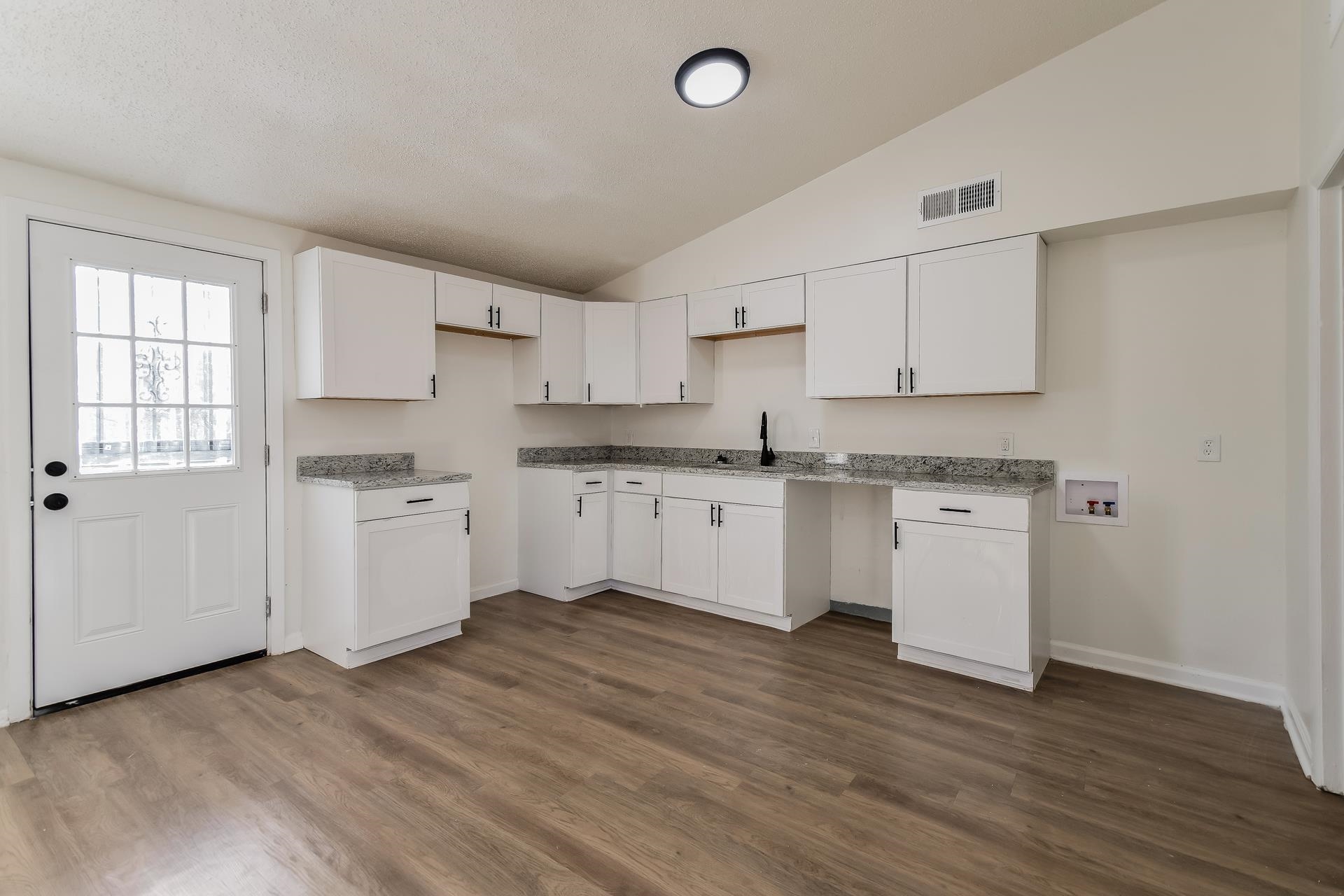 2966 Knight Road Memphis, TN 38118 - Photo 6 of 19 a kitchen with granite countertop white cabinets and white appliances