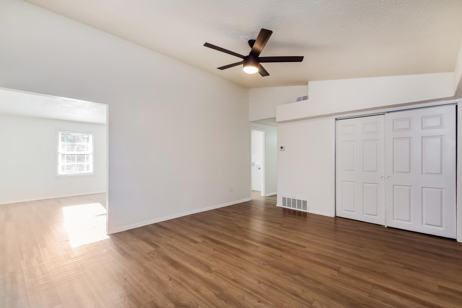 2966 Knight Road Memphis, TN 38118 - Photo 9 of 19 a view of an empty room with wooden floor and a ceiling fan