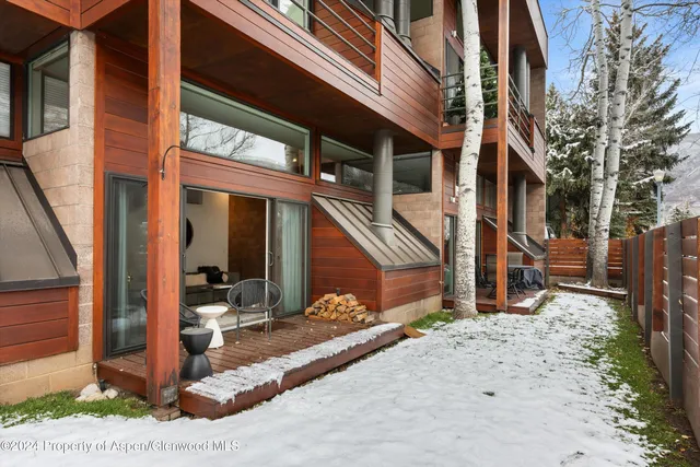 a front view of a house with yard and seating space