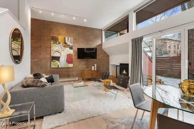 a living room with fireplace furniture and a flat screen tv
